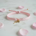 Pulsera cruz dorada con corazón para boda